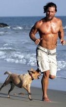Matthew McConaughey stays in shape running on the beach with with his dog