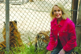 Tippi Hedren hanging with some big cats.