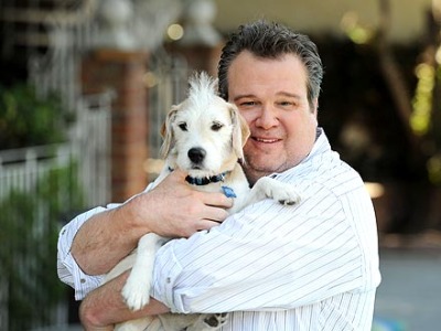 Coleman gets puppy loving from his puppy parent, Eric Stonestreet.