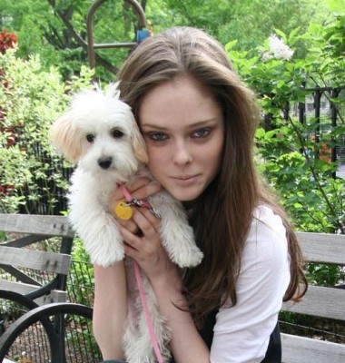 Coco Rocha posing in the park with her dog.