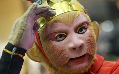 In this Wednesday, Feb. 3, 2016 photo, a Chinese man, dressed as the legendary Monkey God of Chinese folklore adjusts his mask and prepares before a show at Seacon Square in Bangkok, Thailand. The event was part of celebrations for the Chinese New Year which falls on Feb. 8 this year to mark the year of the monkey. (AP Photo/Sakchai Lalit, File)